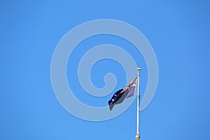 Australia flag on blue sky background.