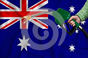 AUSTRALIA flag Close-up shot on waving background texture with Fuel pump nozzle in hand. The concept of design solutions. 3d