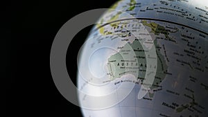 Australia map on a globe with black background.