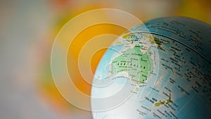 Australia map on a globe with earth map in the background.