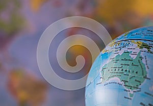 Australiamap on a globe with earth map in the background.