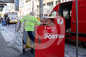 Australia Post postal worker collecting mails from the mal box