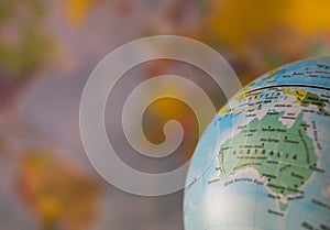 Australiamap on a globe with earth map in the background.