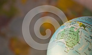 Australiamap on a globe with earth map in the background.