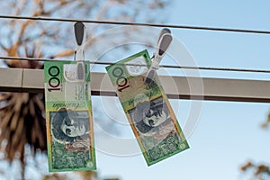 Australian 100 dollar bank notes hanging out to dry on a clothes line