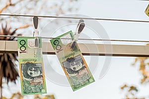 Australian 100 dollar bank notes hanging out to dry on a clothes line