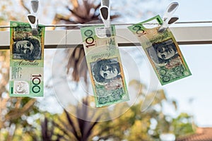 Australian 100 dollar bank notes hanging out to dry on a clothes line