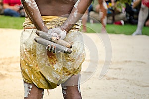 Australian aboriginal people holding Traditional Wood Claves percussion instruments.