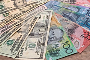 Australian and american dollar banknotes on wooden table