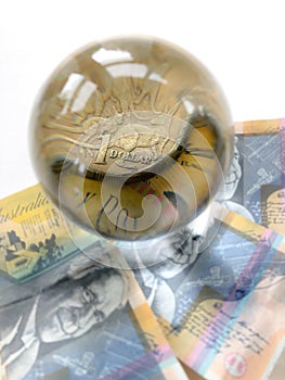 Australian banknotes, coin and crystal ball on whitebackround