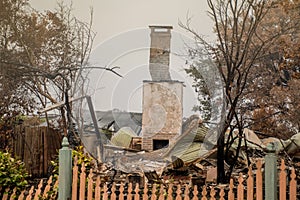 Australian bushfire aftermath: A lonely chimney on burnt building remains