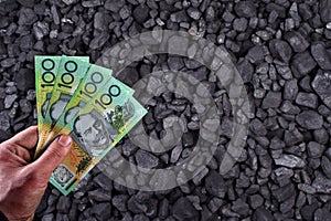 Australian currency showed on coal of mine deposit mineral resources background
