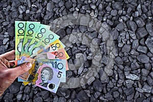 Australian currency showed on coal of mine deposit mineral resources background