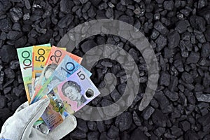 Australian currency showed on coal of mine deposit mineral resources background