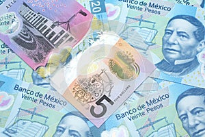 An Australian dollar bank note with Mexican twenty peso bank notes