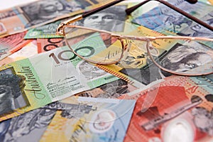 Australian dollar banknotes with glasses close up