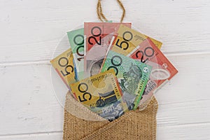 Australian dollar banknotes with material envelope on light background