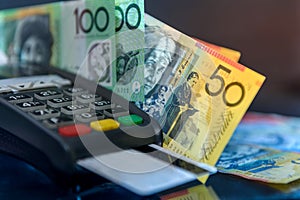 Australian dollar banknotes with terminal and credit card