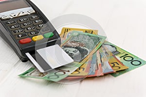 Australian dollar banknotes with terminal and credit card