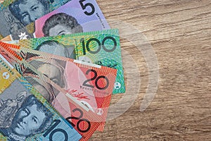 Australian dollar banknotes on wooden table close up