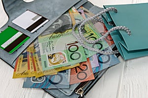 Australian dollars with credit cards in wallet and gift bag