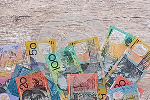 Australian dollars on wooden table as background