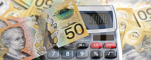 Australian fifty dollar bill and calculator.