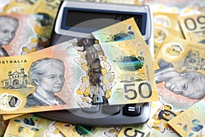 Australian fifty dollar bill and calculator.