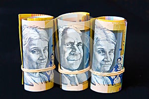 Australian fifty dollar notes rolled with elastic bands.