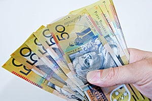 Australian Fifty dollar notes spread in hand. photo