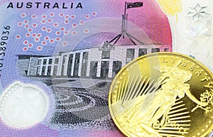 A Australian five dollar banknote with a gold coin in macro