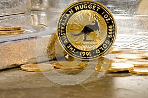Australian Gold Nugget Coin with Silver Bars in Background