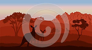 Australian landscape. Kangaroo silhouettes. Savannah scenery of Australia. Panoramic wildlife scene. Wilderness dusk