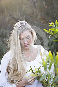 Australian with Long Blond Hair Touching Tree