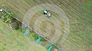 Australian man riding ride on lawn mower cutting green