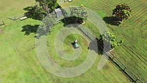 Australian man riding ride on lawn mower cutting green