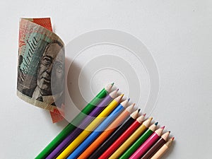 Australian money and color pencils on the white background