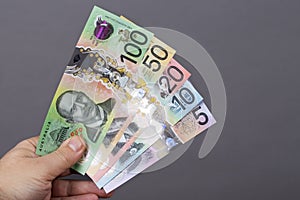 Australian money in the hand on a gray background