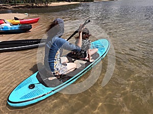 Australian mother and daughter row together on stand up paddle board