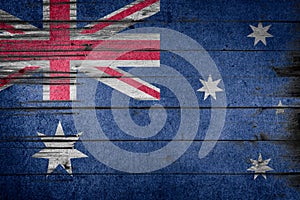 Australian national flag on wooden rustic background.