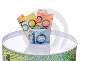 Australian notes stuffed in to a money tin