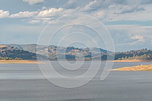 Australian outback landscape with lake and distant hills