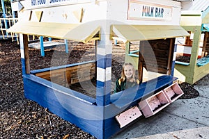 An australian school girl in a pretend shop playground