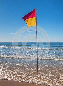 Australian surf safety flag on the beach on a sunny day