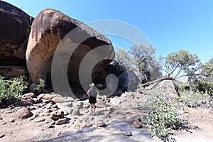 Australian woman hiker looking at Hippo`s Yawn Rock Hyden Western Australia