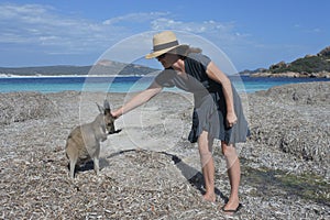 Australian woman petting a Kangaroos in Lucky Bay Western Australia