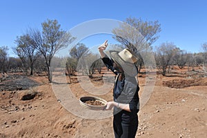 Australian woman searching gem stones in Australia outback