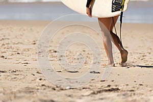 Australian Woman surfer walking along the Beach whit her Surfboard. Noosa, Queensland, Australia