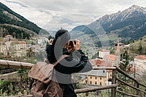 Austria. Bad Gastein. Girl traveler with a retro camera k is on the obser photo