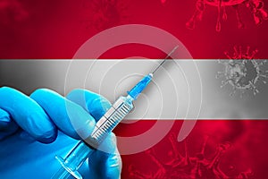 Austria Covid-19 Vaccination Campaign. Hand in a blue rubber glove holds a syringe with covid-19 virus vaccine in front of Austria
